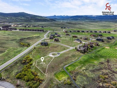 Lot 6 offers a generous build site bordered by natural landscape and a paved cul-de-sac, moments from the clubhouse. Lot lines shown are approximate.