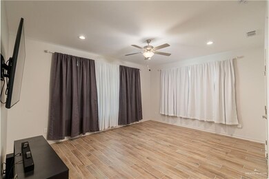 Empty room with ceiling fan, light wood-style flooring, and recessed lighting
