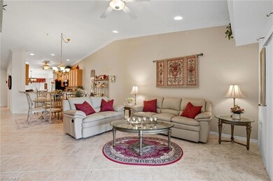 Living room with ceiling fan, vaulted ceiling, crown molding, light tile patterned floors, and recessed lighting