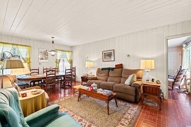 Living area featuring brick flooring