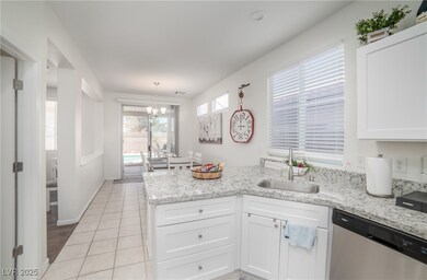 Kitchen with dishwasher, a sink, a peninsula, whit