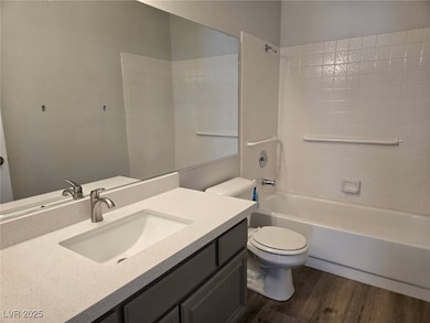 Bathroom featuring wood finished floors, vanity, b