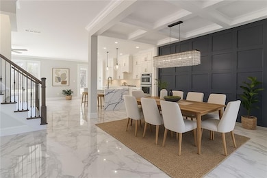 Dining space featuring crown molding, marble finish floor, visible vents, and stairs. Virtually Staged