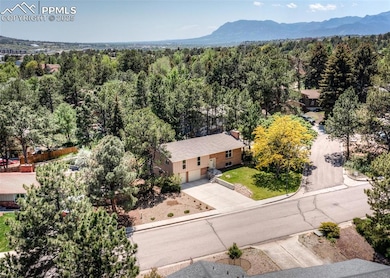 Drone / aerial view of a heavily wooded area and mountains