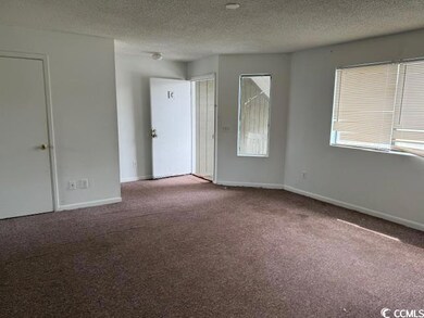Unfurnished room featuring carpet flooring, basebo