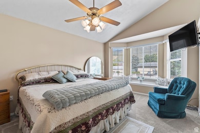 Master bedroom includes French doors, bay window with window seat, and vaulted ceiling