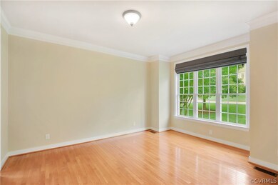 Living Room with Hardwood Floors and Crown Molding