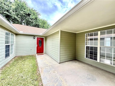 Entrance to property featuring a carport and a pat