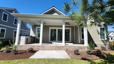 Property entrance featuring a ceiling fan and board and batten siding