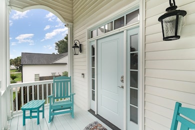 View of exterior entry with covered porch