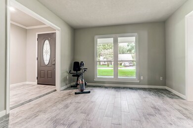 Upon entering the home, a new front door with glass insert welcomes you in this ranch style home. The stunning wood look tile floor, in a staggered pattern, creates a soothing flow from room to room. New energy efficient windows frame the view, which looks out into the front of the home.  This is the formal living room, but can be used as a craft room, exercise room, your choice!