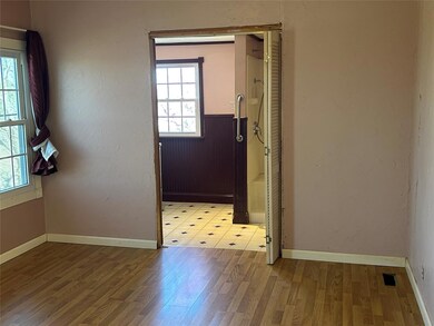 Unfurnished room featuring baseboards, a healthy 