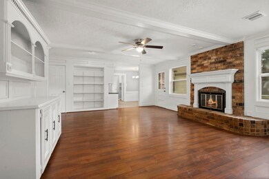 Living room with fireplace and built-ins.