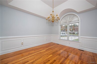 Dining room has gleaming hardwood flooring, tray c