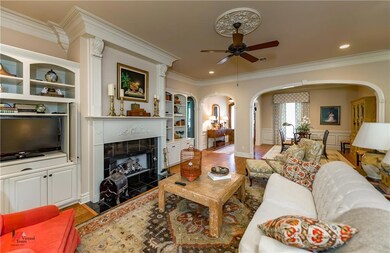 Living room with fireplace and gas logs.  Wood flo