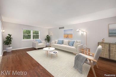 Living area with dark wood-style floors and baseboards