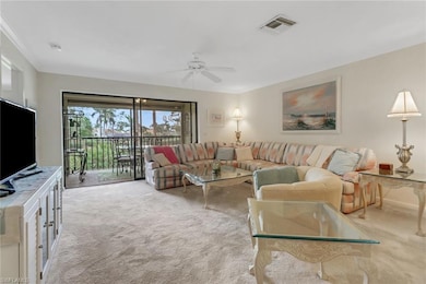 Living area featuring ornamental molding, carpet f