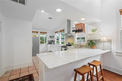 FRESHLY PAINTED CABINETRY AND MARBLE COUNTERTOPS