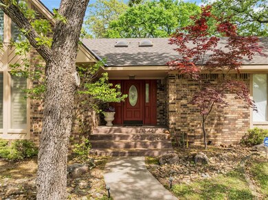 Doorway to property featuring a shingled roof and 