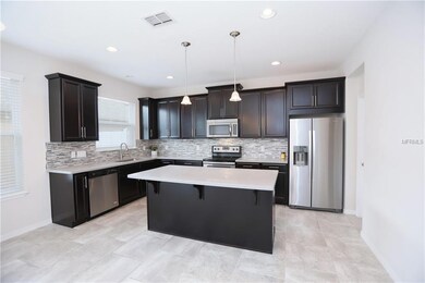 Kitchen with beautiful modern backsplash and cente