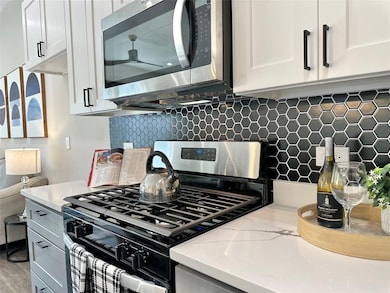 Bold black hexagon tile backsplash contrasts beaut