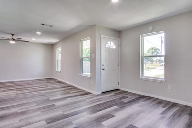 Entrance foyer featuring ceiling fan and light har