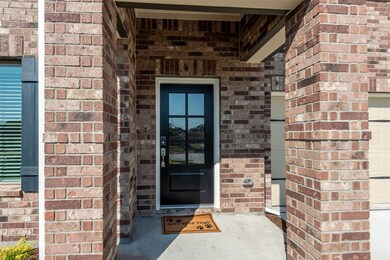 Beautiful front entry door with digital electronic smartlock and brushed nickel hardware welcomes you.