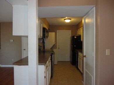 Kitchen appliances remain.  Kitchen floor is tile.
