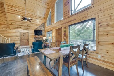 Dining room with beamed ceiling, wooden walls, hig