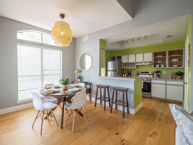 Dining room with light wood-style flooring and rail lighting