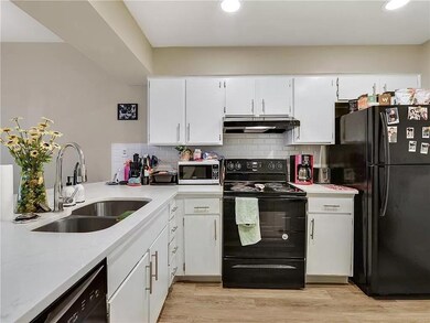 Kitchen with black appliances, under cabinet rang