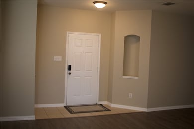 Entrance foyer featuring baseboards and light wood-style floors