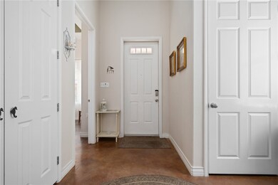 Entry with extra high ceilings, a large coat close