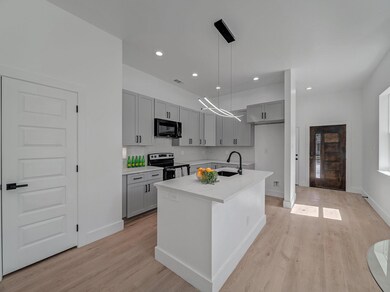Kitchen with light countertops, electric stove, bl