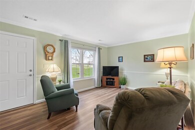 Living Room with large front window & crown moldin