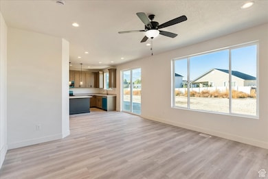Unfurnished living room with recessed lighting, light wood-style flooring, and a ceiling fan