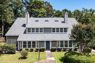 View of front of home with a chimney, roof with shingles, and a front lawn