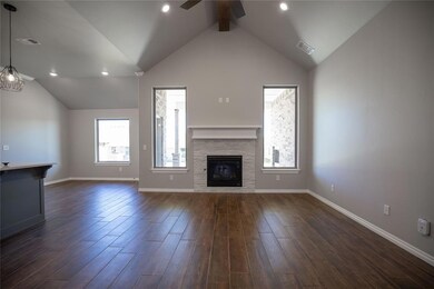 Unfurnished living room with high vaulted ceiling,