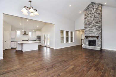 Hargrove- Luxury Kitchen overlooking the great room and stone fireplace. Photo for representation purposes only. 