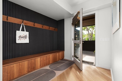Mudroom featuring wood finished floors and basebo