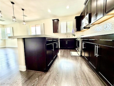Kitchen featuring dark wood-type flooring, white m