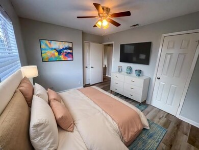 Bedroom with visible vents, baseboards, wood fini