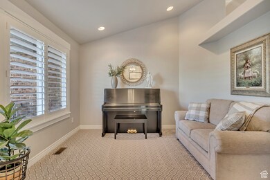 Sitting room with lofted ceiling, carpet floors, and recessed lighting