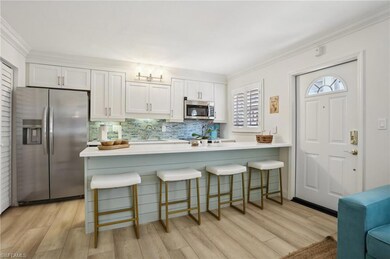 Kitchen with sink, stainless steel appliances, lig