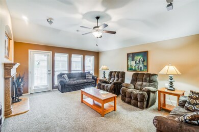 Carpeted living room featuring a high end fireplac