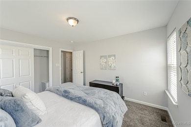 Bedroom featuring carpet floors, a closet, visible