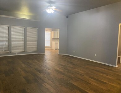 Spare room with ceiling fan and dark hardwood / wood-style flooring