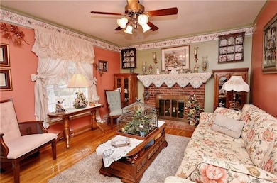 Cute living room with fireplace. Oak Floors!