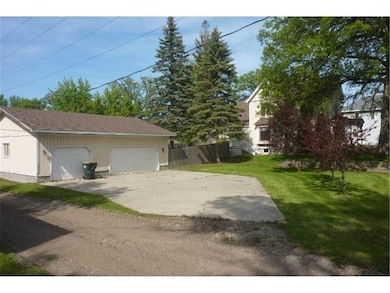 Large concrete driveway leading to the huge garage