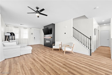 Unfurnished living room featuring a fireplace, sta